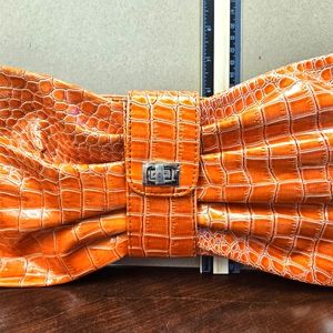 Vintage orange faux leather bow clutch